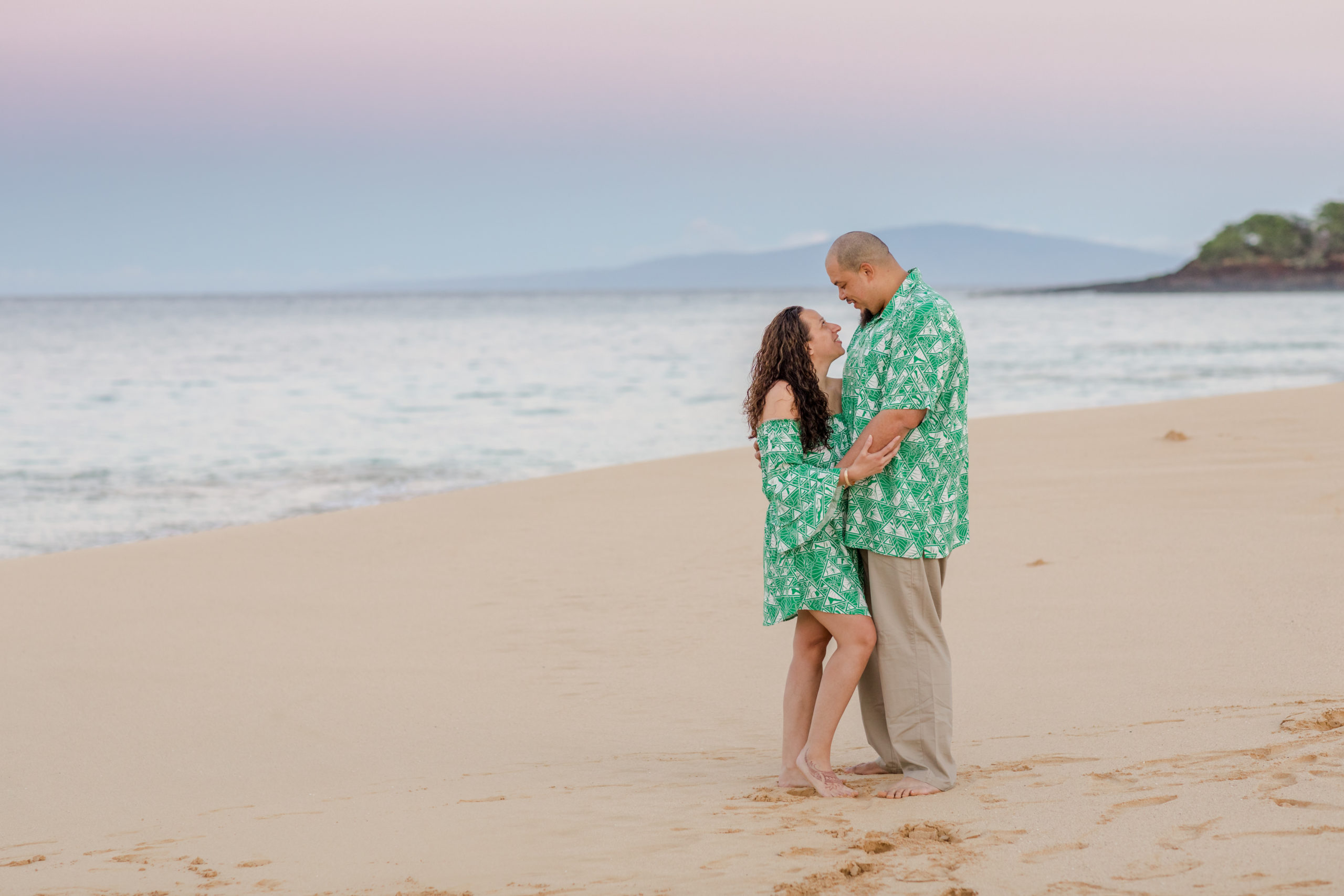Couple on a Maui beach at sunrise